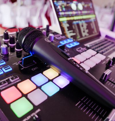 Close-up image of DJ equipment with mixer, microphone and laptop. Close-up image of DJ equipment with mixer, microphone and laptop.